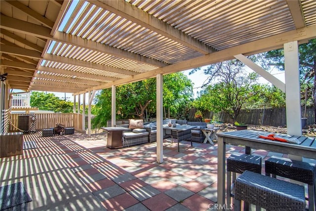 view of patio featuring an outdoor hangout area, a fenced backyard, and a pergola