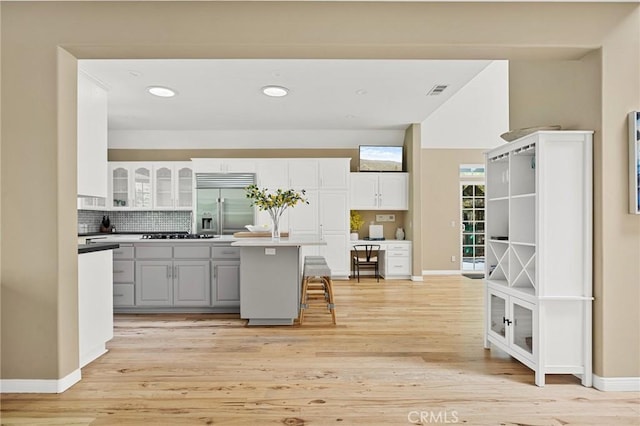 28537 N Shore Rd, Lake Arrowhead, CA 92352 - kitchen featuring built in fridge, white cabinetry, decorative backsplash, light wood finished floors, and recessed lighting