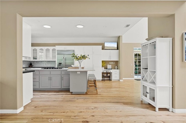 28537 N Shore Rd, Lake Arrowhead, CA 92352 - kitchen featuring built in refrigerator, white cabinets, backsplash, light wood-style floors, and recessed lighting