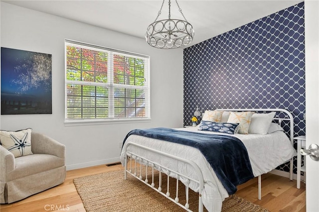28537 N Shore Rd, Lake Arrowhead, CA 92352 - bedroom featuring an accent wall and wood finished floors