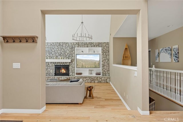 28537 N Shore Rd, Lake Arrowhead, CA 92352 - living room featuring wood finished floors, baseboards, and a fireplace