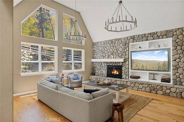 28537 N Shore Rd, Lake Arrowhead, CA 92352 - living room with wood finished floors, a stone fireplace, high vaulted ceiling, and baseboards
