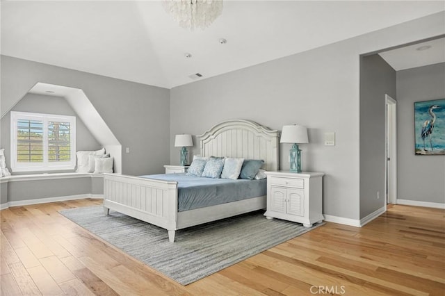 28537 N Shore Rd, Lake Arrowhead, CA 92352 - bedroom with lofted ceiling, light wood-type flooring, and baseboards