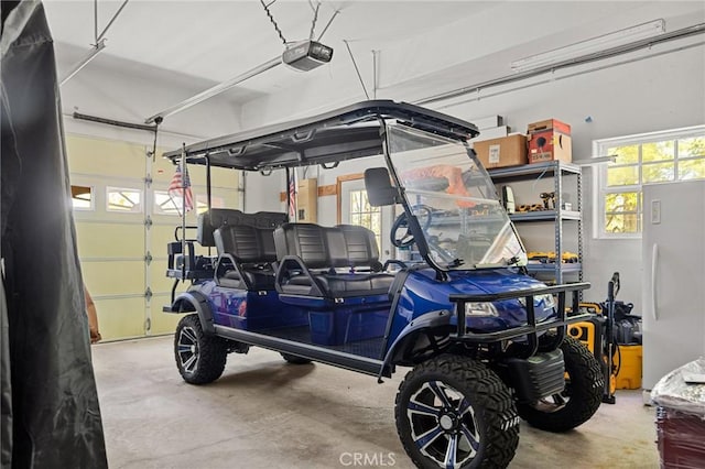 28537 N Shore Rd, Lake Arrowhead, CA 92352 - garage featuring a garage door opener and freestanding refrigerator
