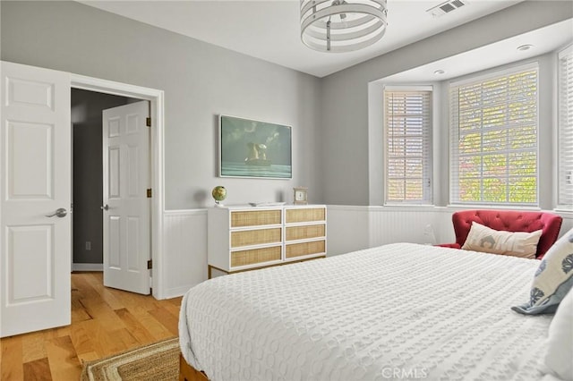 28537 N Shore Rd, Lake Arrowhead, CA 92352 - bedroom with a wainscoted wall and wood finished floors