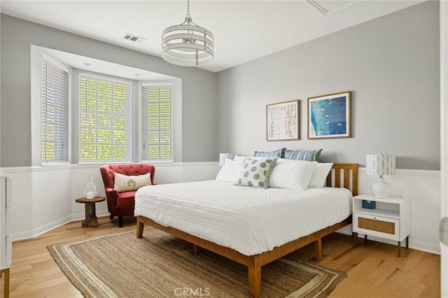 28537 N Shore Rd, Lake Arrowhead, CA 92352 - bedroom with wainscoting and light wood-type flooring