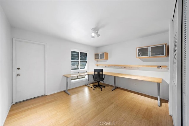16851 Morse Cir, Huntington Beach, CA 92649 - home office featuring built in study area, wood finished floors, and baseboards
