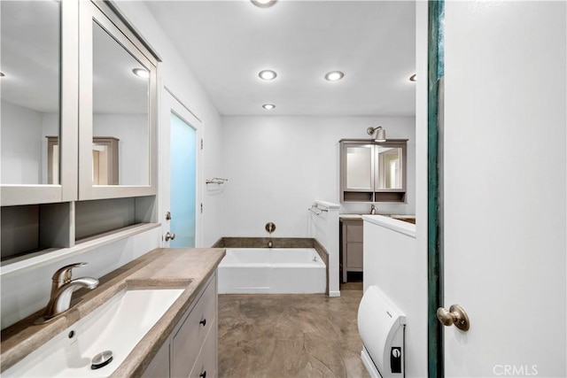 16851 Morse Cir, Huntington Beach, CA 92649 - bathroom with a garden tub, vanity, recessed lighting, and concrete floors