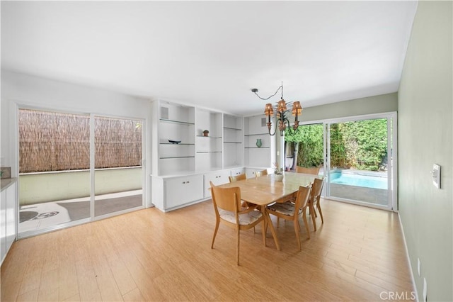 16851 Morse Cir, Huntington Beach, CA 92649 - dining space featuring a chandelier, light wood-style flooring, and baseboards