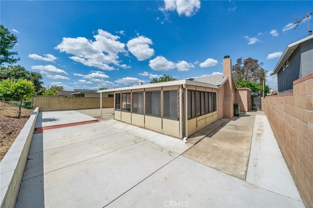 19508 Springport Dr, Rowland Heights, CA 91748 - rear view of property featuring a sunroom, a patio area, and a chimney