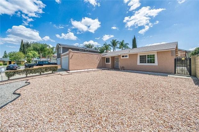 19508 Springport Dr, Rowland Heights, CA 91748 - rear view of property featuring stucco siding, an attached garage, and a gate