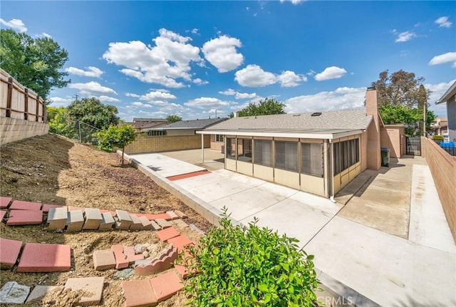19508 Springport Dr, Rowland Heights, CA 91748 - back of house featuring a sunroom, a patio, a fenced backyard, and a chimney