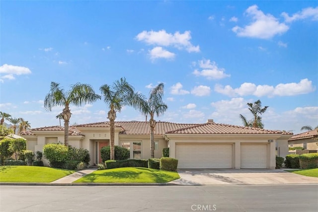75929 Camino Cielo, Indian Wells, CA 92210 - view of front of house featuring a tile roof, an attached garage, stucco siding, concrete driveway, and a front lawn