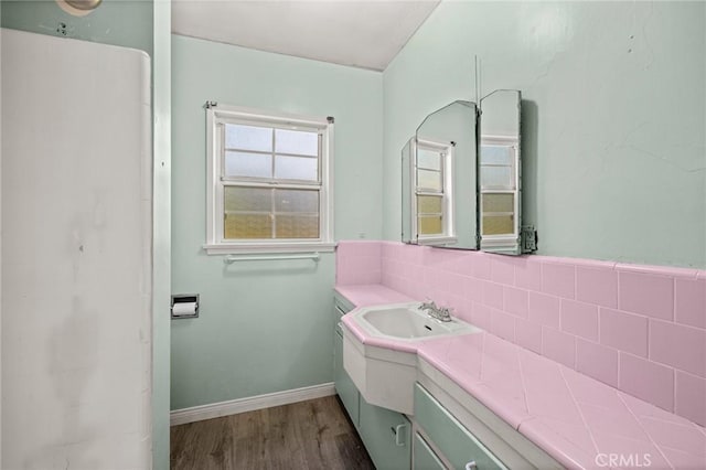 1506 W 5th St, San Pedro, CA 90732 - bathroom featuring decorative backsplash, wood finished floors, vanity, and baseboards
