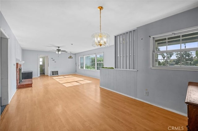 1506 W 5th St, San Pedro, CA 90732 - unfurnished living room featuring wood finished floors, a ceiling fan, a chandelier, a fireplace, and baseboards