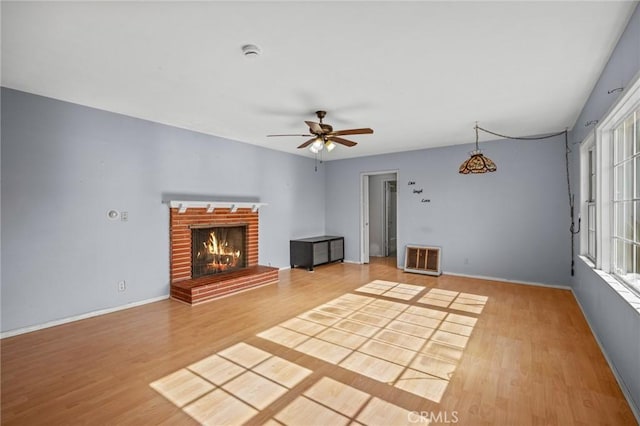 1506 W 5th St, San Pedro, CA 90732 - unfurnished living room with light wood finished floors, a ceiling fan, a brick fireplace, and baseboards