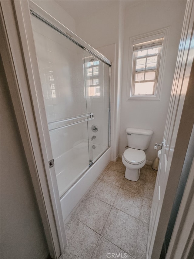 13529 Scarlet Sage Trl, San Diego, CA 92130 - bathroom featuring toilet, tile patterned floors, enclosed tub / shower combo, and baseboards