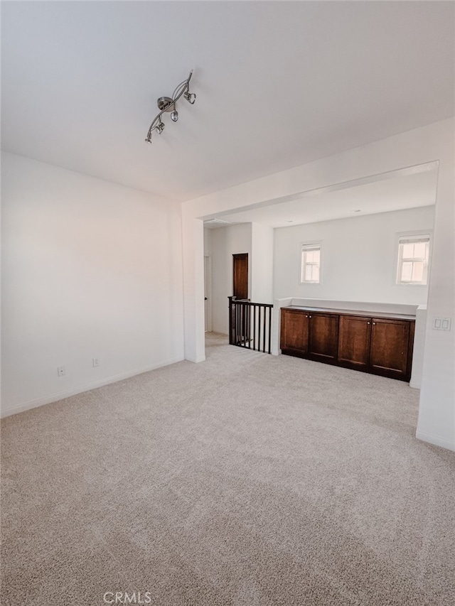 13529 Scarlet Sage Trl, San Diego, CA 92130 - empty room featuring carpet floors, track lighting, and baseboards