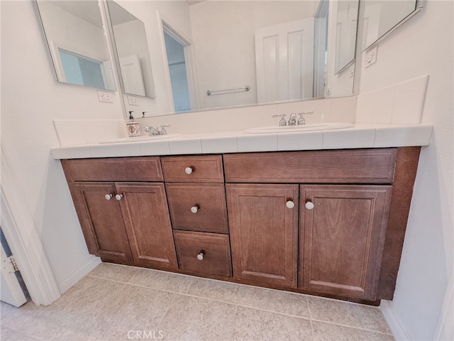 13529 Scarlet Sage Trl, San Diego, CA 92130 - bathroom with double vanity, baseboards, and tile patterned floors