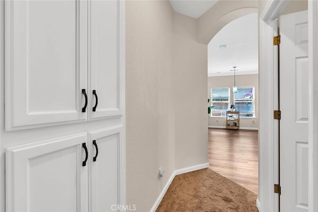 3008 La Vina Cir, Los Banos, CA 93635 - corridor with baseboards, arched walkways, and carpet flooring