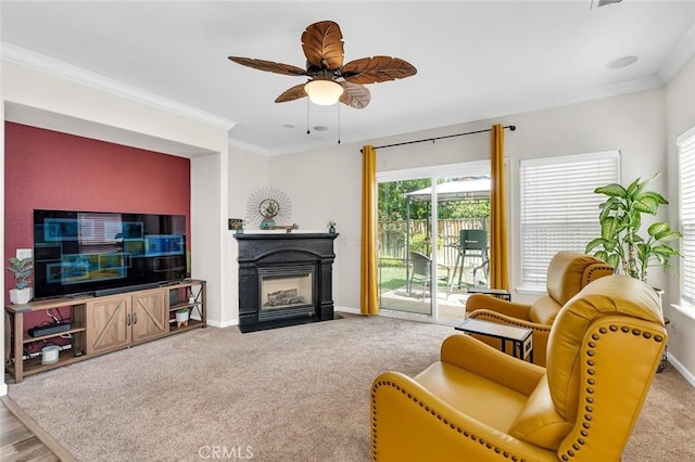 3008 La Vina Cir, Los Banos, CA 93635 - living room with baseboards, a ceiling fan, a fireplace with flush hearth, ornamental molding, and carpet