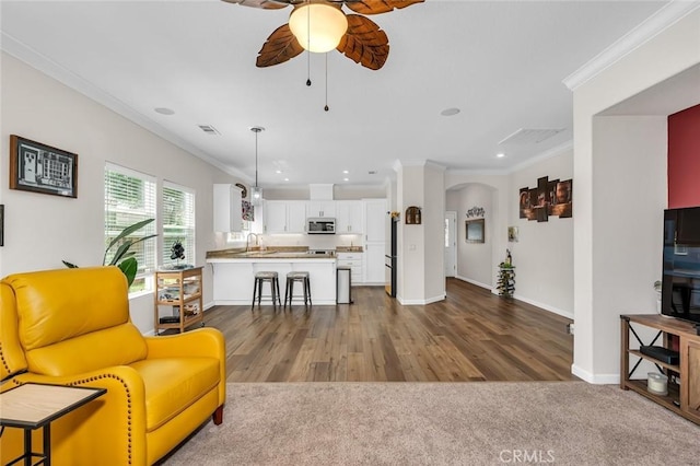 3008 La Vina Cir, Los Banos, CA 93635 - living room featuring a ceiling fan, ornamental molding, arched walkways, baseboards, and recessed lighting