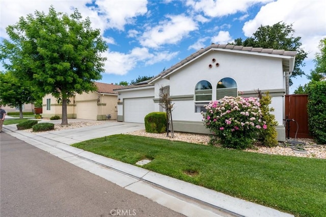 3008 La Vina Cir, Los Banos, CA 93635 - mediterranean / spanish house featuring a garage, driveway, stucco siding, and a tile roof