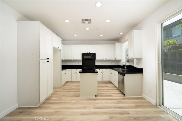8063 Cambria Cir, Stanton, CA 90680 - kitchen featuring black microwave, a sink, stainless steel dishwasher, a center island, and white cabinetry