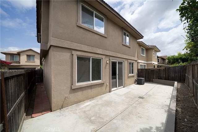 8063 Cambria Cir, Stanton, CA 90680 - back of property with stucco siding, a patio, and a fenced backyard