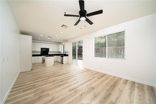8063 Cambria Cir, Stanton, CA 90680 - unfurnished living room with baseboards, light wood-style flooring, recessed lighting, ceiling fan, and a sink