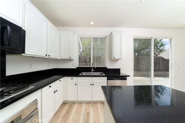 8063 Cambria Cir, Stanton, CA 90680 - kitchen featuring a sink, black appliances, healthy amount of natural light, white cabinetry, and recessed lighting