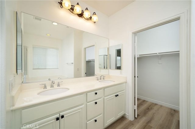 8063 Cambria Cir, Stanton, CA 90680 - full bathroom featuring wood finished floors, a spacious closet, double vanity, and a bath