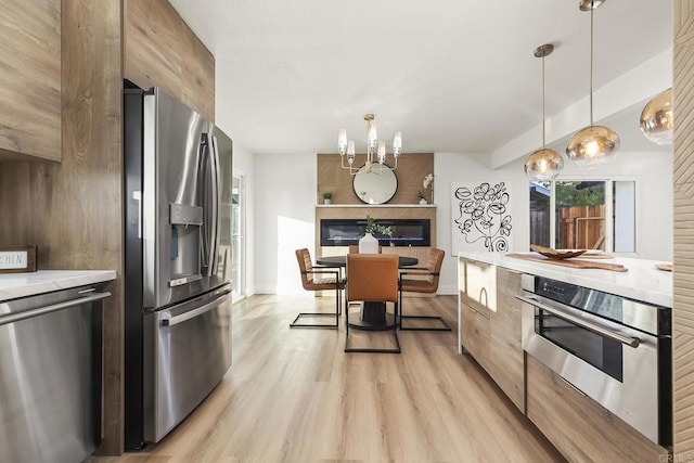 6802 Maury Dr, San Diego, CA 92119 - kitchen featuring appliances with stainless steel finishes, light countertops, modern cabinets, and light wood-style floors