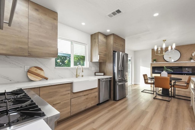 6802 Maury Dr, San Diego, CA 92119 - kitchen featuring appliances with stainless steel finishes, tasteful backsplash, light wood-type flooring, modern cabinets, and recessed lighting