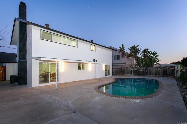 6802 Maury Dr, San Diego, CA 92119 - pool at dusk featuring a patio, a fenced backyard, and central AC unit