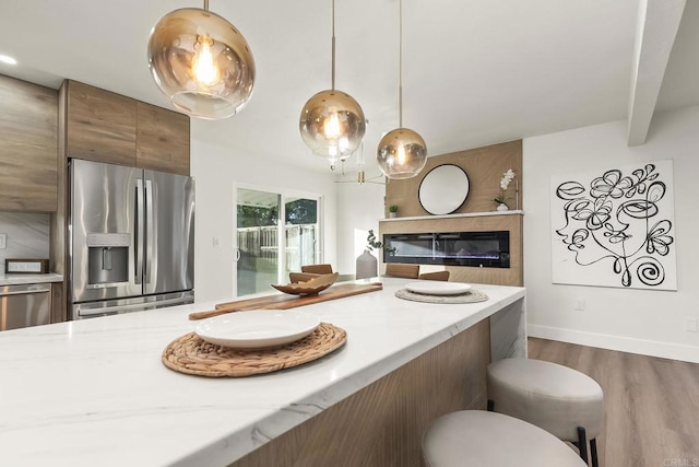 6802 Maury Dr, San Diego, CA 92119 - kitchen featuring stainless steel fridge with ice dispenser, dark wood-style flooring, pendant lighting, light stone counters, and brown cabinetry