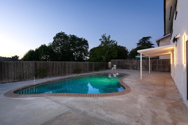 6802 Maury Dr, San Diego, CA 92119 - pool at dusk featuring a patio and a fenced backyard