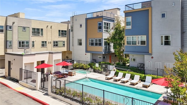 2753 Waverly Dr Unit 304, Los Angeles, CA 90039 - rear view of property with a community pool, a patio, stucco siding, and a residential view