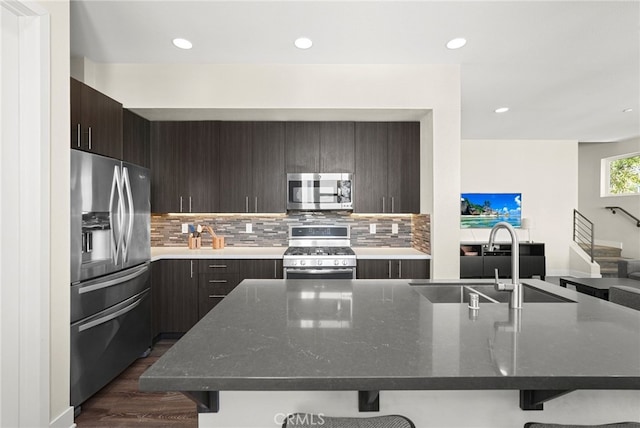 2753 Waverly Dr Unit 304, Los Angeles, CA 90039 - kitchen with appliances with stainless steel finishes, modern cabinets, a kitchen bar, a sink, and tasteful backsplash