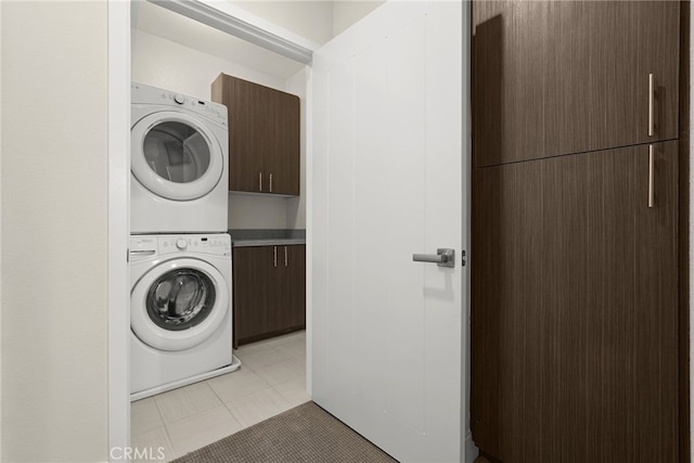 2753 Waverly Dr Unit 304, Los Angeles, CA 90039 - laundry room with stacked washing machine and dryer, cabinet space, and light tile patterned floors