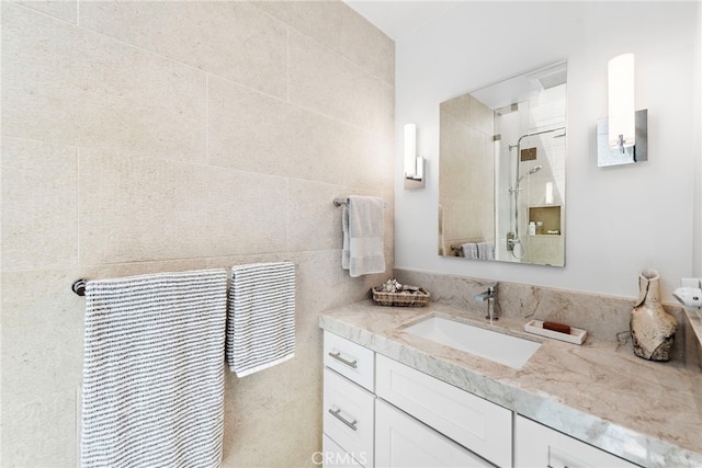 full bath featuring vanity and a shower
