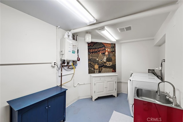 washroom with independent washer and dryer, water heater, and cabinet space