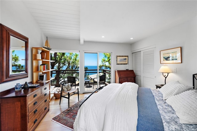 bedroom with a closet, light wood-type flooring, recessed lighting, and access to exterior