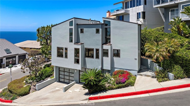 683 Alta Vista Way, Laguna Beach, CA 92651 - view of building exterior featuring a garage, a water view, and driveway