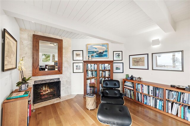 683 Alta Vista Way, Laguna Beach, CA 92651 - sitting room featuring a wooden ceiling with exposed beams, wood finished floors, and a tiled fireplace