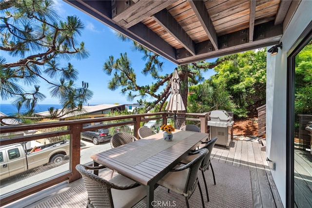 wooden deck with area for grilling and outdoor dining space