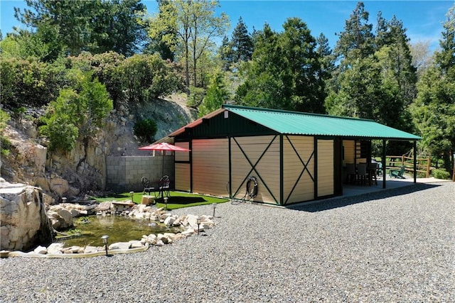 26061 Augusta Dr, Lake Arrowhead, CA 92391 - view of outdoor structure featuring an outdoor structure, fence, and a garden pond