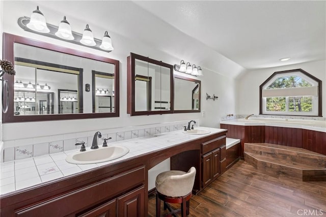 26061 Augusta Dr, Lake Arrowhead, CA 92391 - bathroom with wood finished floors, a garden tub, vaulted ceiling, and double vanity