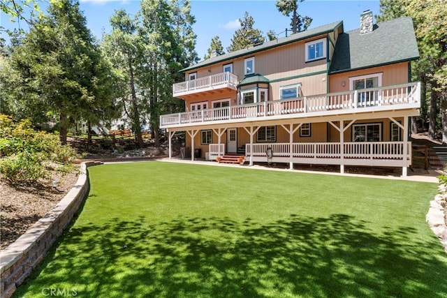 26061 Augusta Dr, Lake Arrowhead, CA 92391 - rear view of property featuring a wooden deck, a chimney, a yard, and a shingled roof