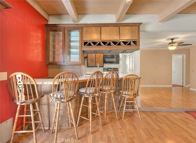 1244 N Albright Ave, Upland, CA 91786 - bar area with black microwave, light wood-style flooring, beam ceiling, a ceiling fan, and baseboards